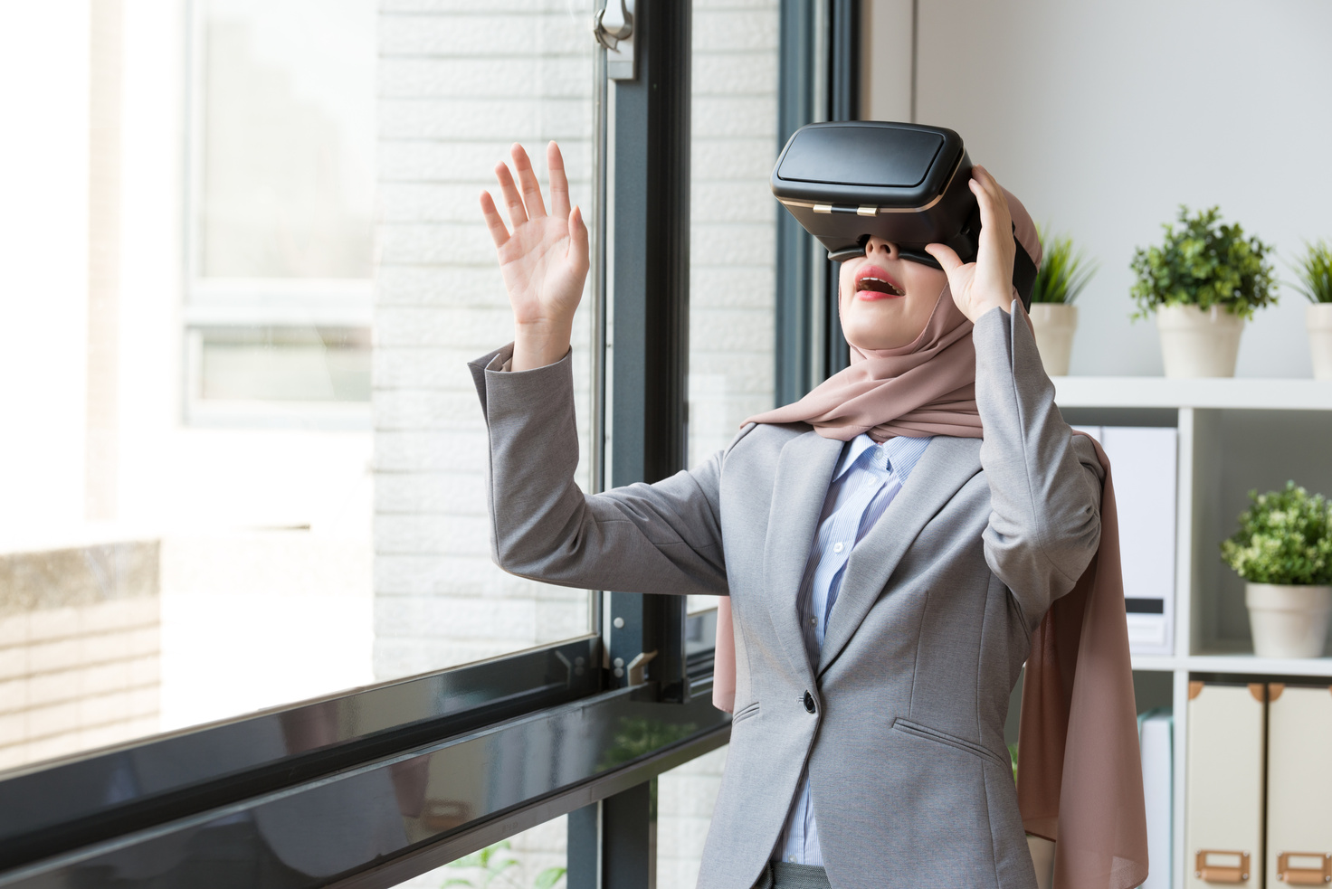muslim woman using virtual reality goggles