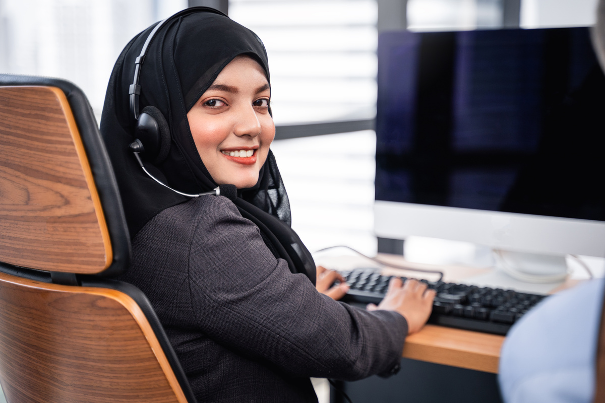 Woman Wearing a Hijab and Headset at Work